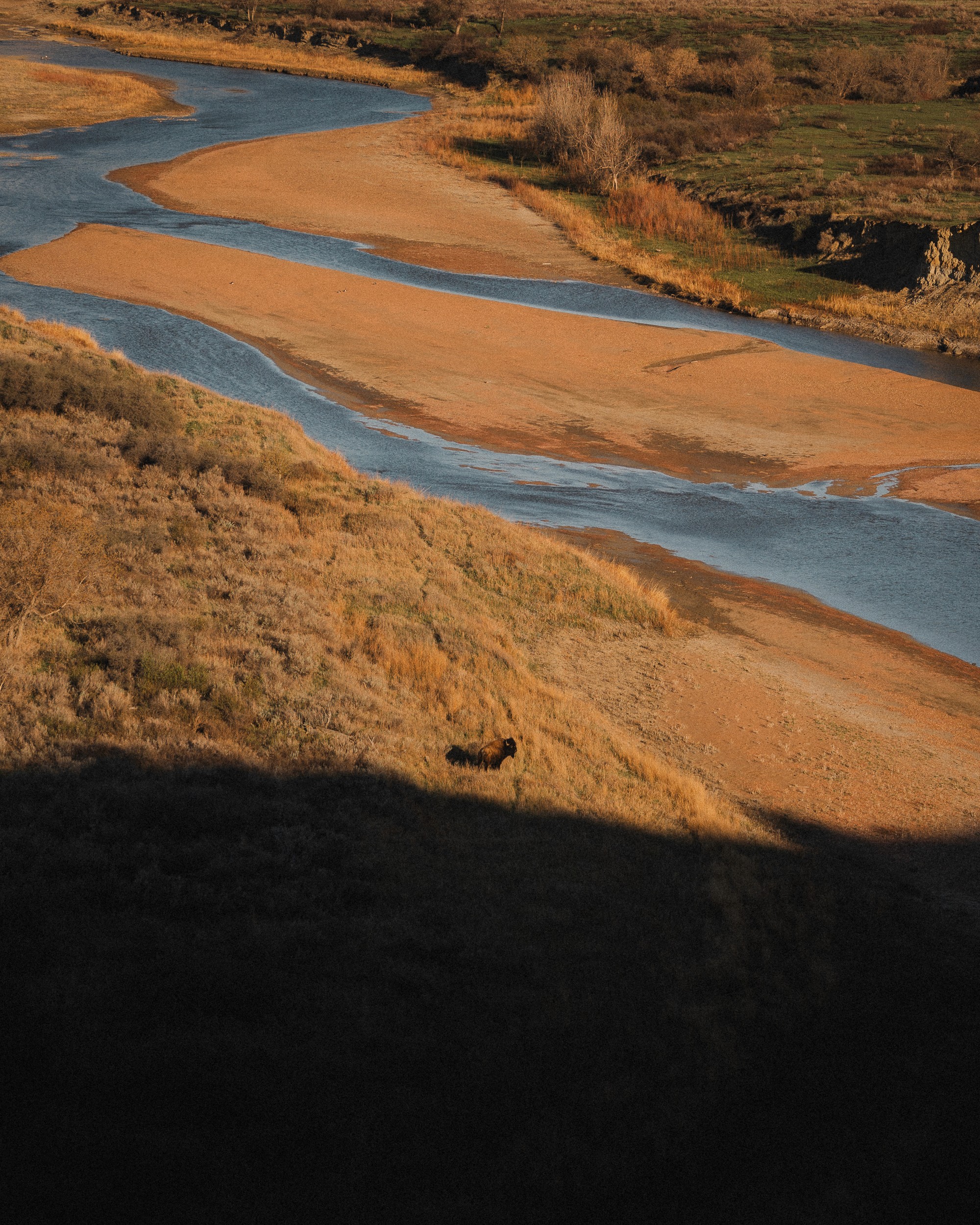 Rippled sand dune texture in shadow and light contrast.