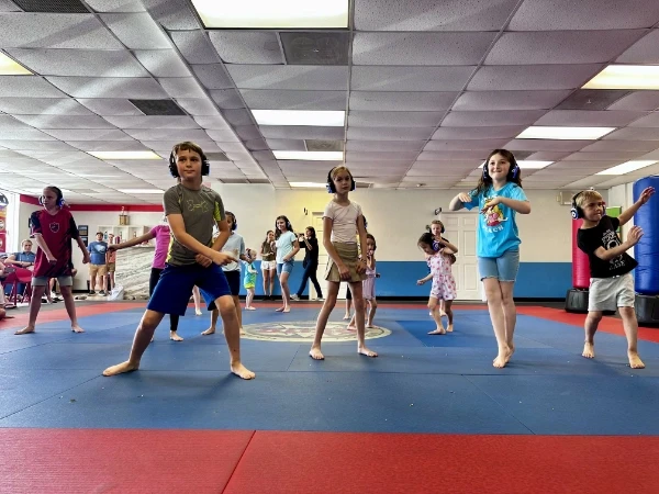 Group of kids dancing with headphones on.