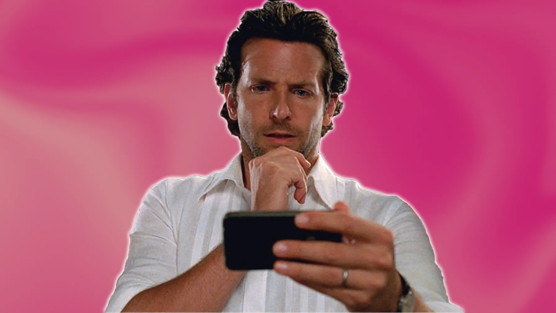 Bradley Cooper stares into his phone