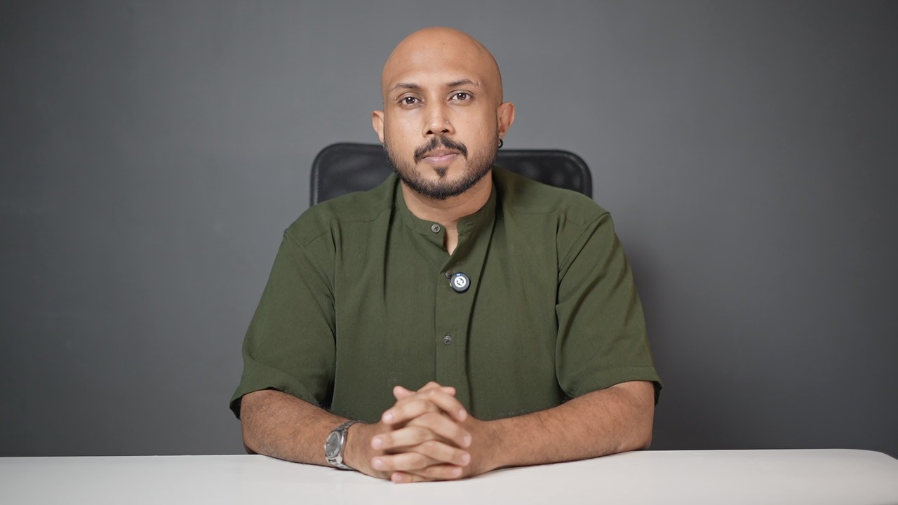 woman in black jacket standing near orange and white bus during daytime