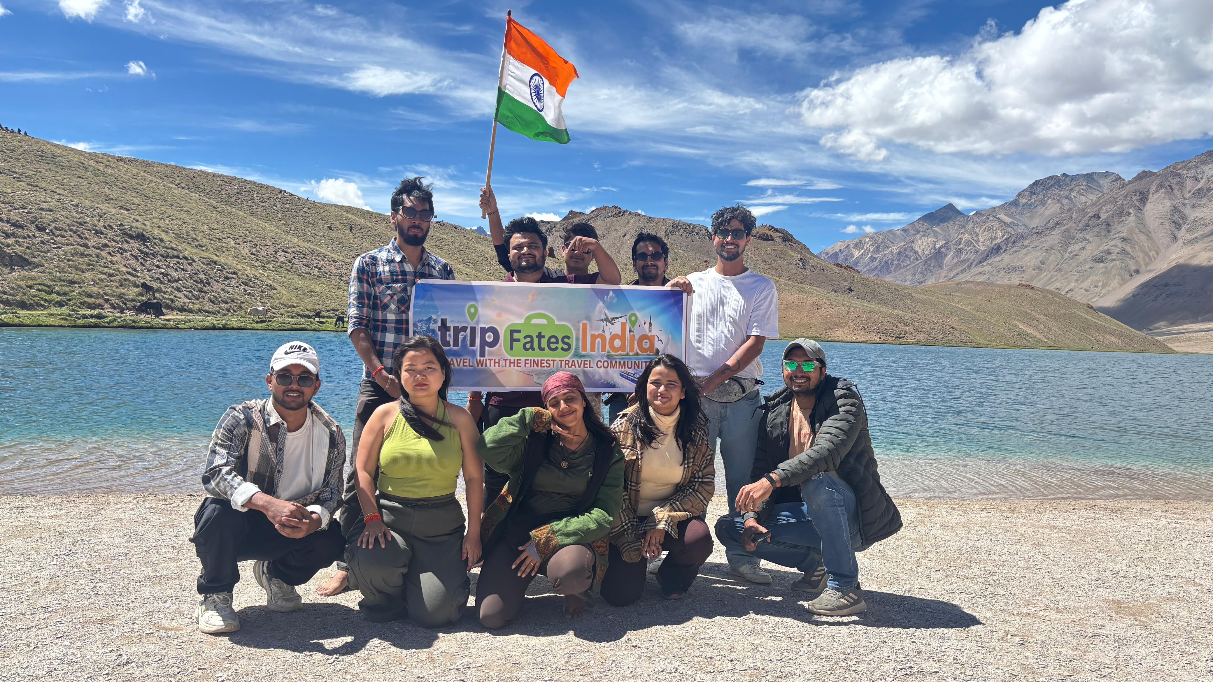 woman in white and red dress standing on green grass field during daytime