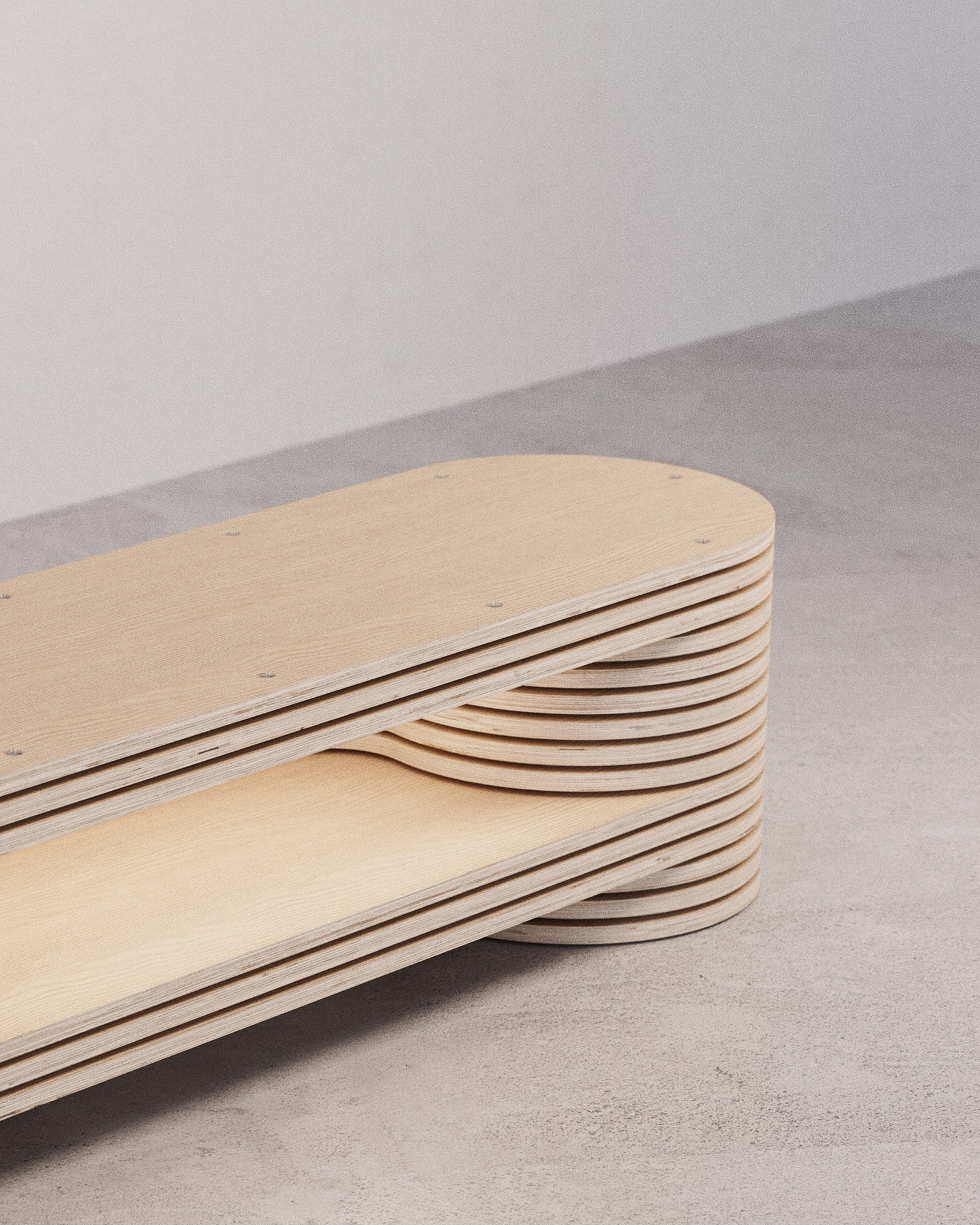 Three-quarter view of layered plywood bench constructed from repeated slices