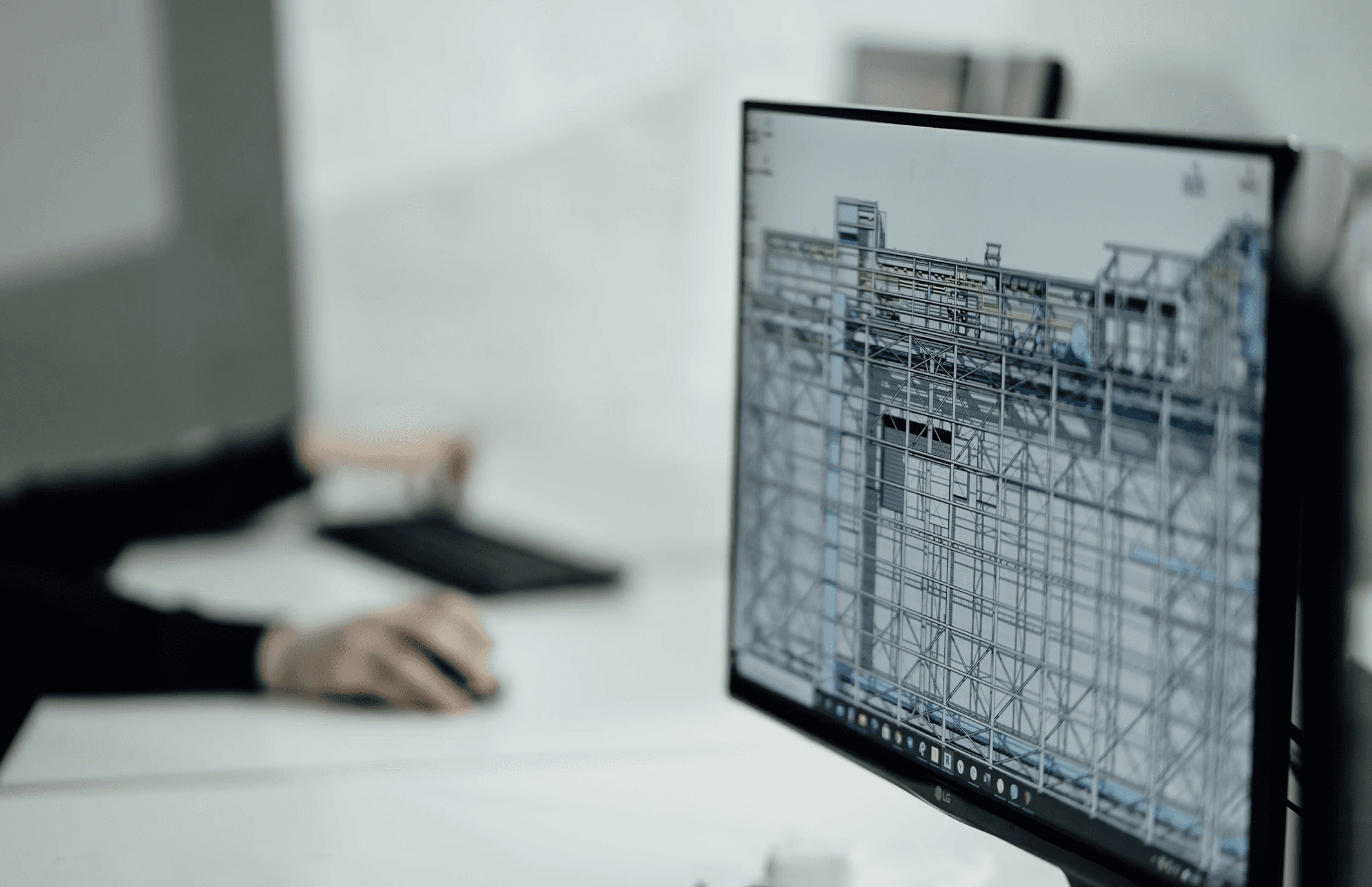 two people sitting at a table with laptops