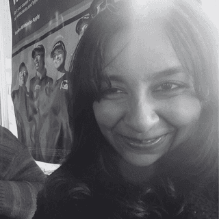 Stylized blue-toned illustration of a bearded man in profile wearing glasses and a collared shirt.