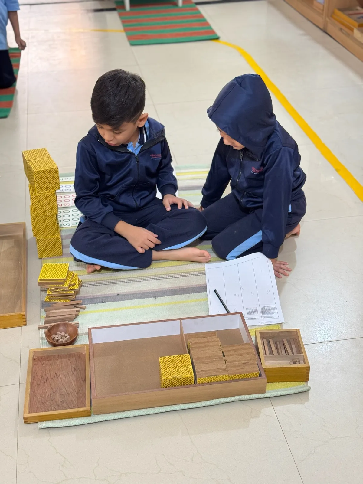 Two kids learning through fun and play at Nebula Montessori 