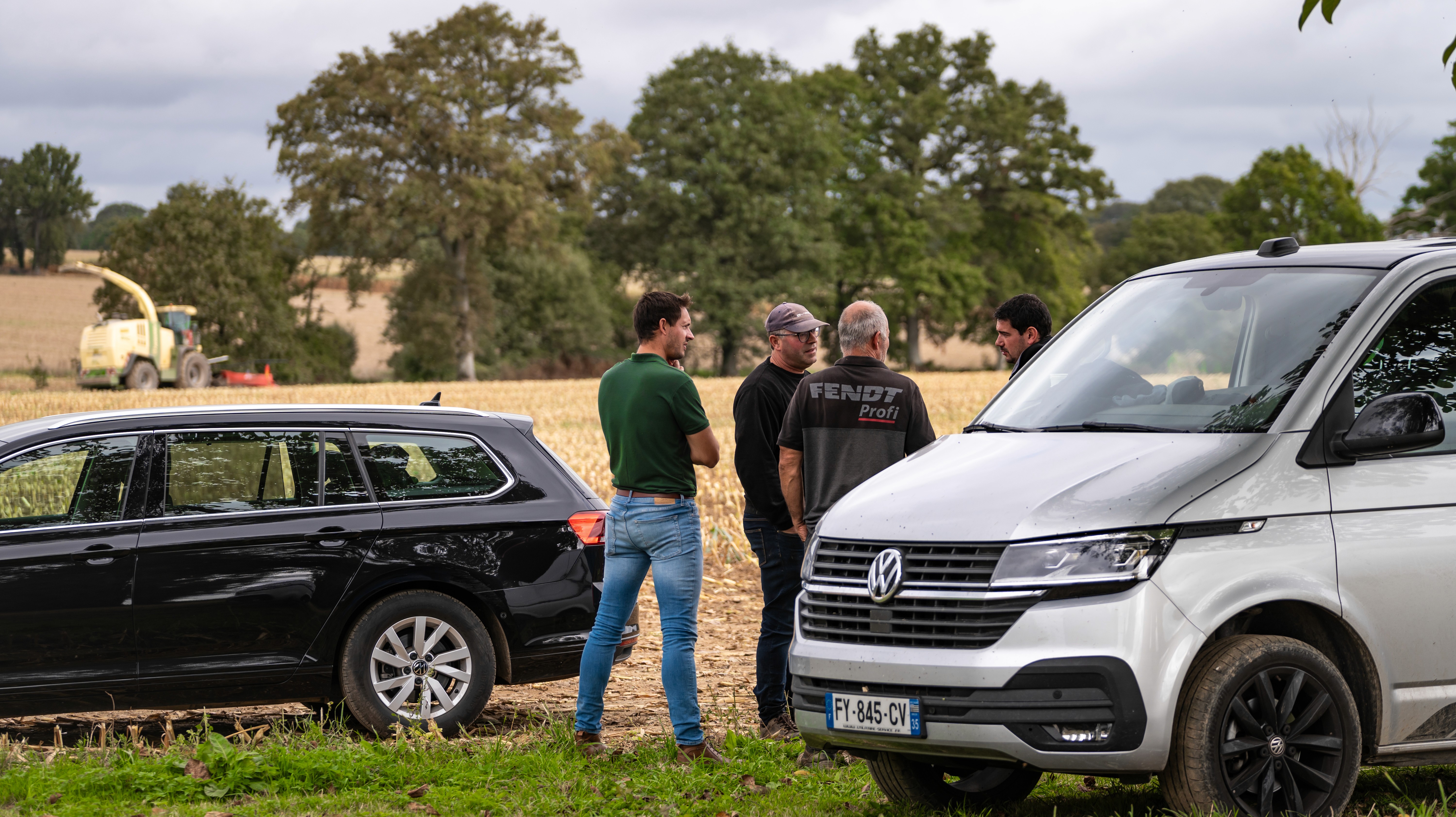 Black and white image of people working at a table with laptops, showing hands gesturing during discussion of digital content displayed on screens, with fabrica® logo in the corner.