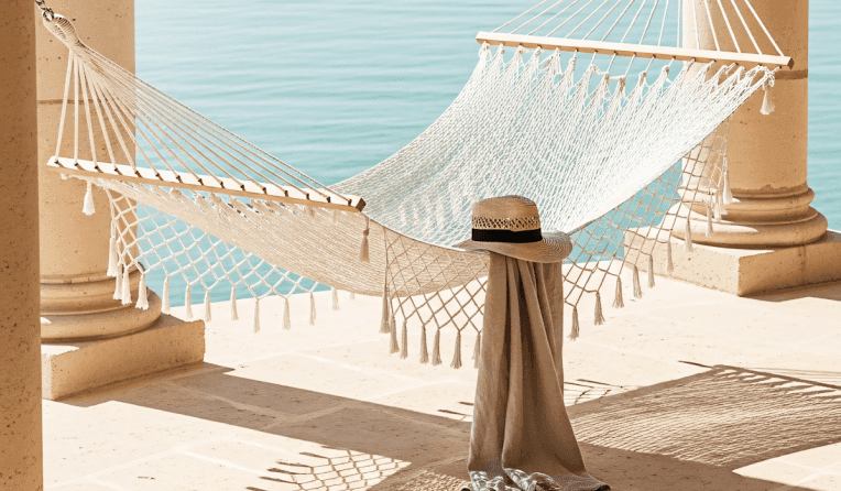 Bright coastal living room with large windows, cozy seating, and ocean views.