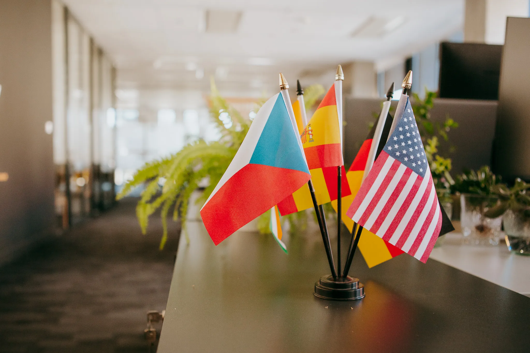A photograph of different country flags on a desk