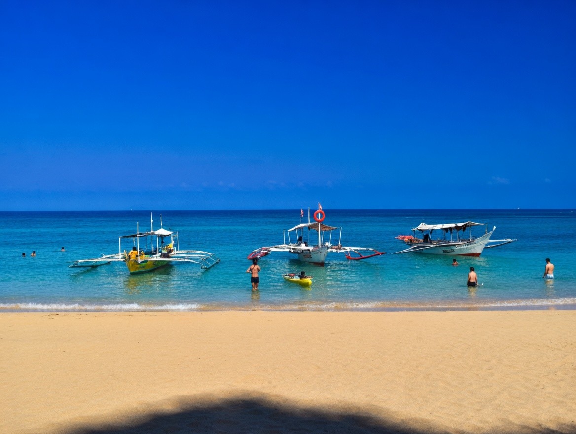 Sandy beach with traditional boats and clear blue water near Oktowaves Hotel Nasugbu