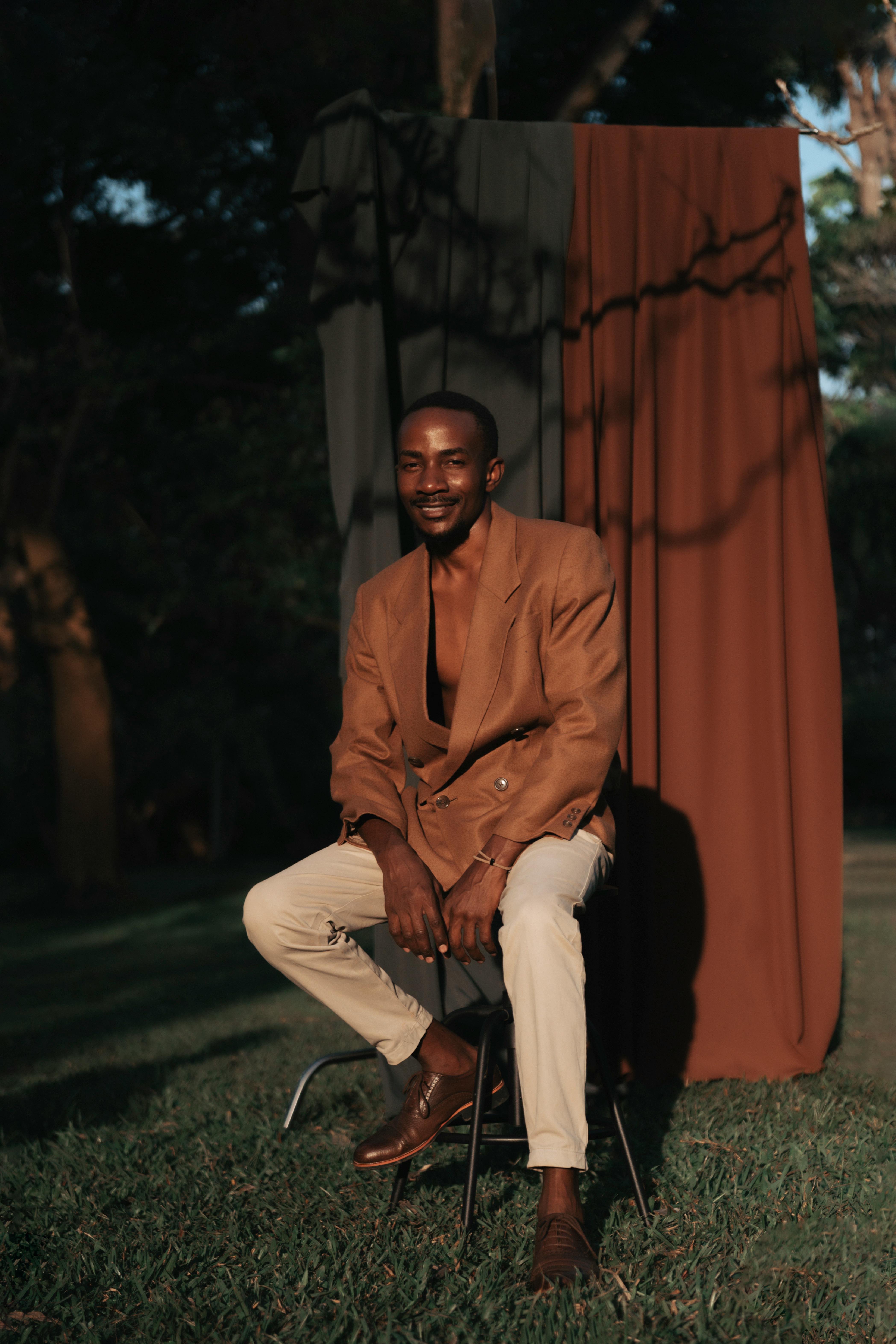 Man sitting posing on a barstool.