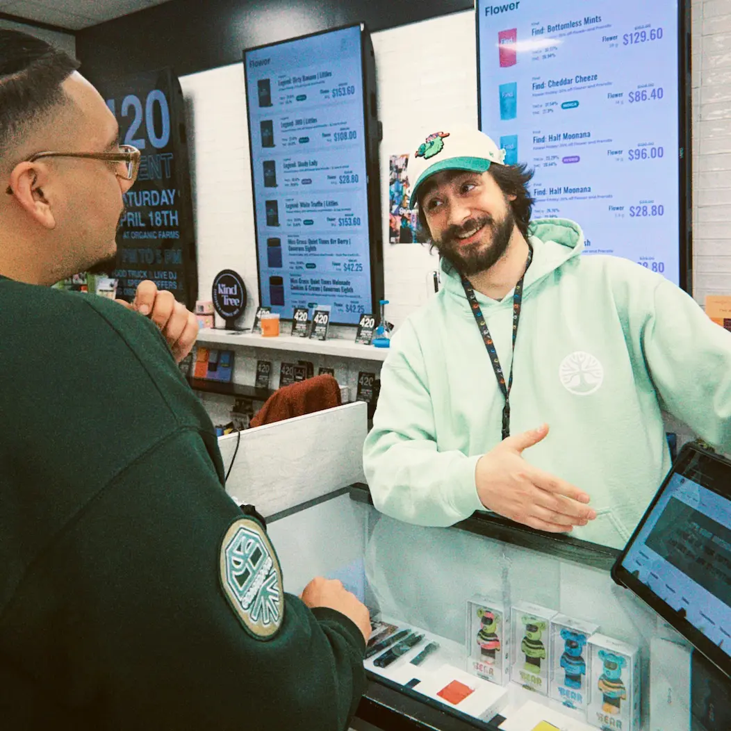 Budtenders assisting customers at the Organic Farms dispensary retail counter in Camden, NJ
