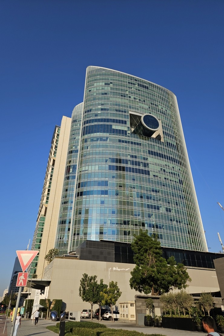 Modern glass facade of commercial property for sale or lease in Dubai.