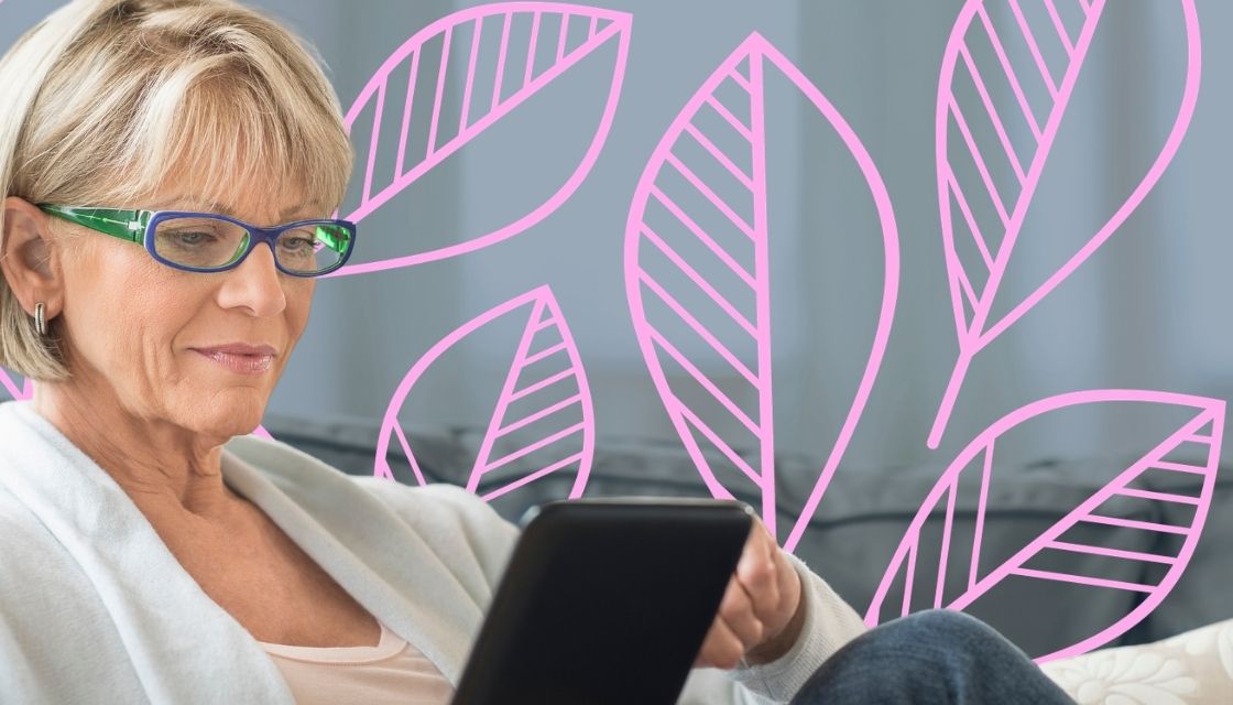Woman with blonde hair and glasses on a tablet