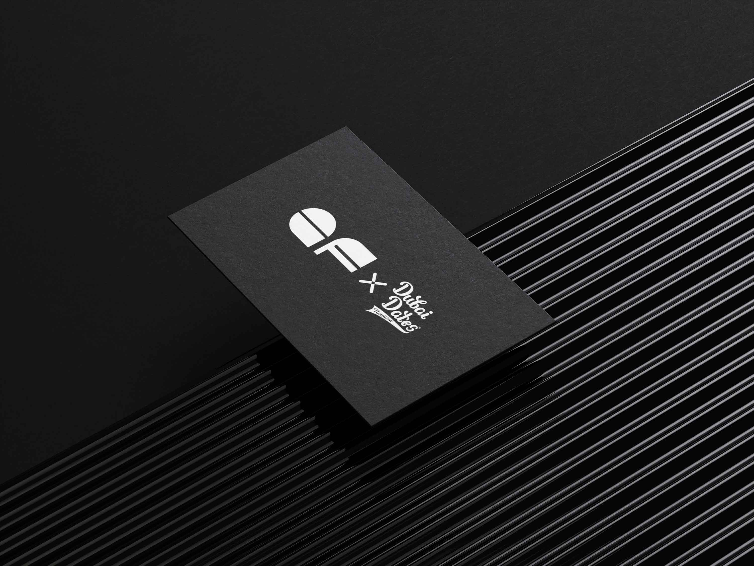 Black business card with white Dubati Dates Nutrition and Elite Fit logos on a black background.