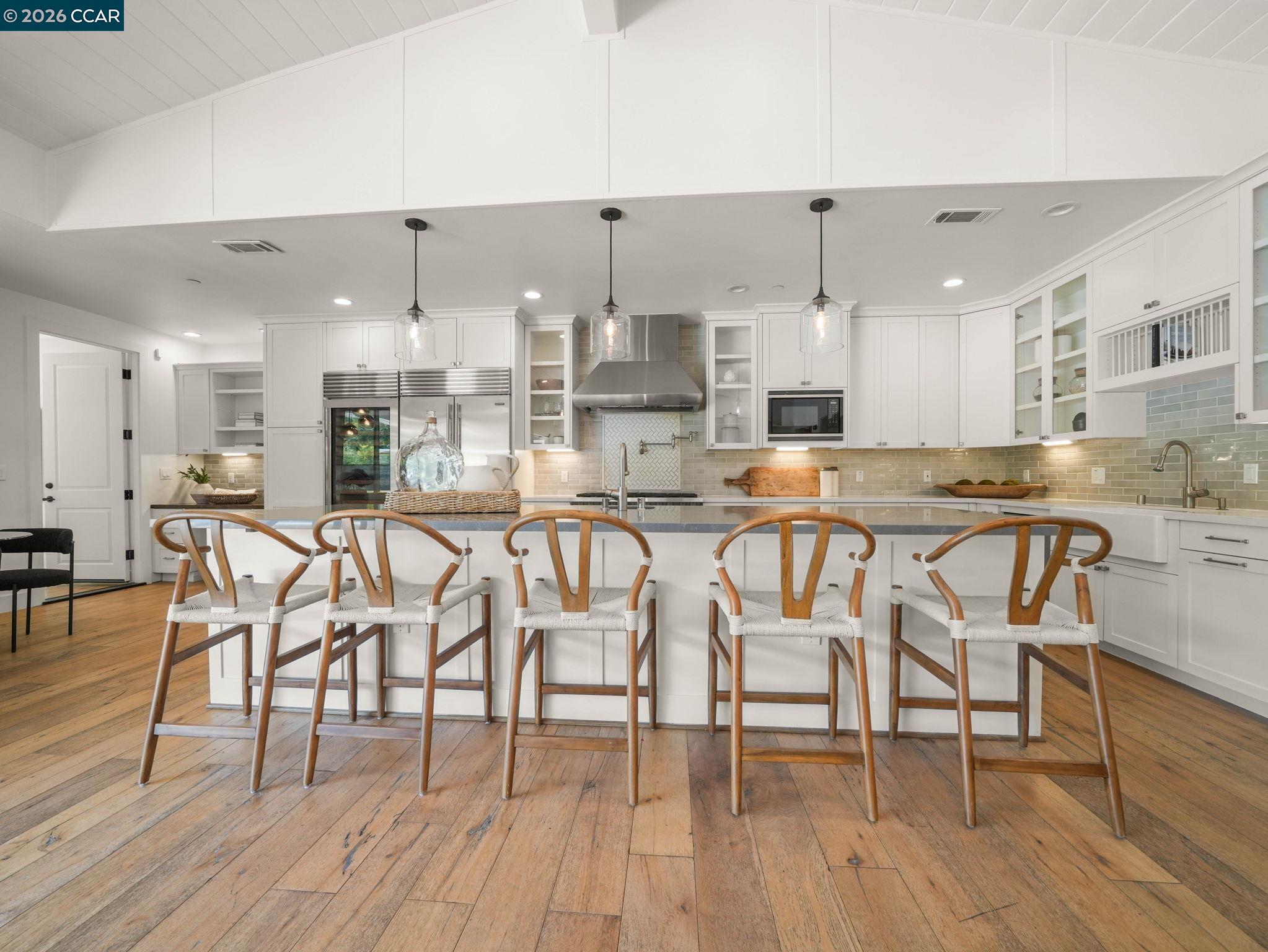 Chef's kitchen at 336 Bonanza Way in Danville with an oversized island, white cabinetry and stainless steel appliances