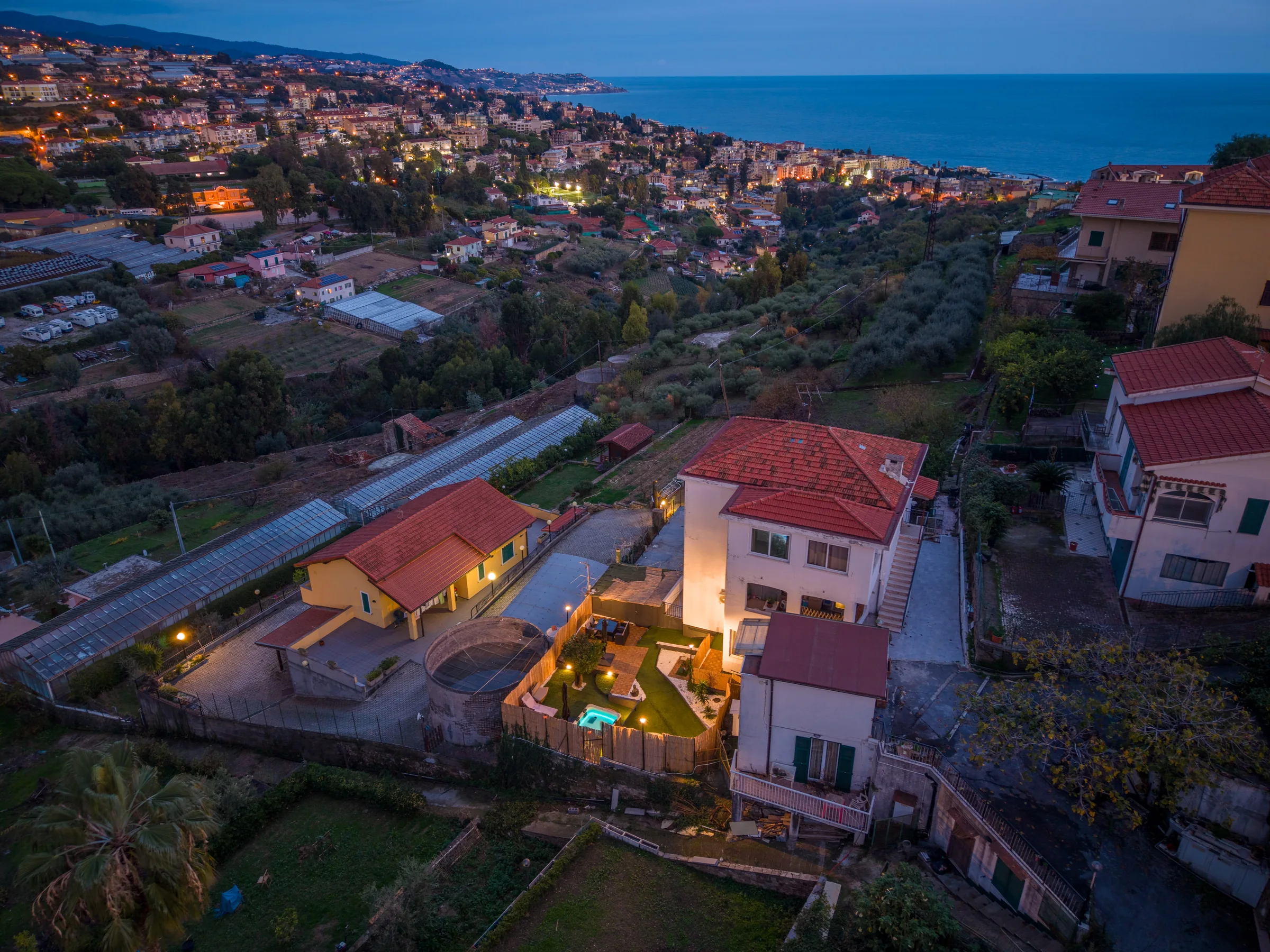 Riviera coastline seen from above at dusk — Province of Imperia, Italy. Photography by Yunes Calore.