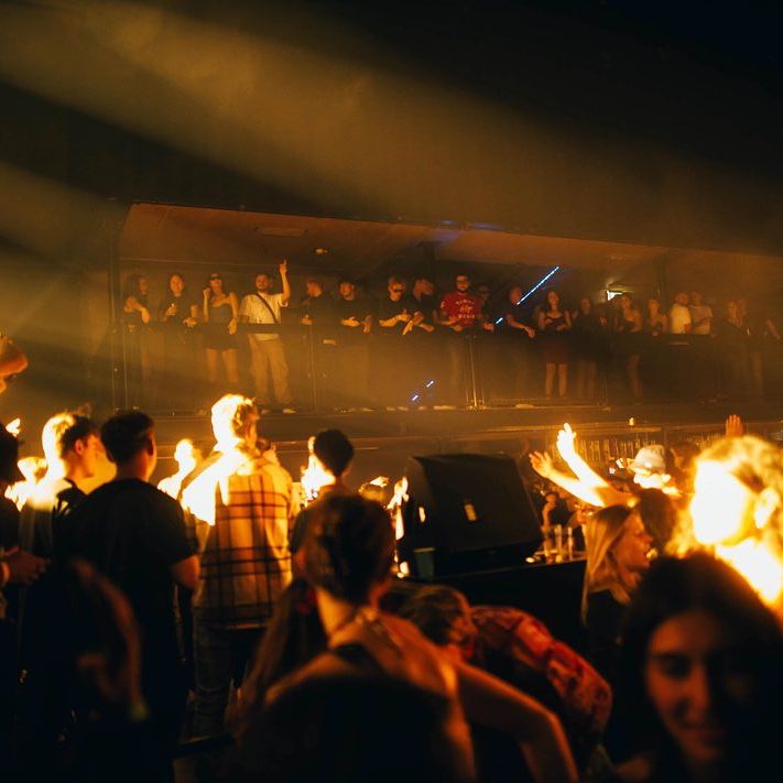 crowd of people at a nightclub dancing