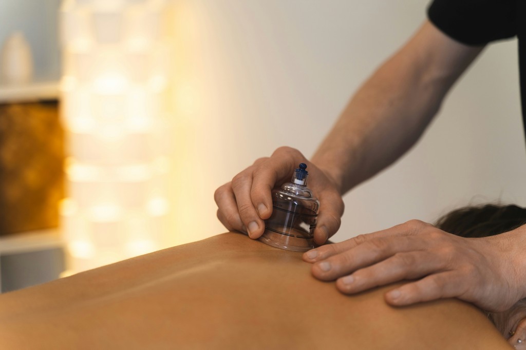 Cupping therapy is being performed on someone's back.