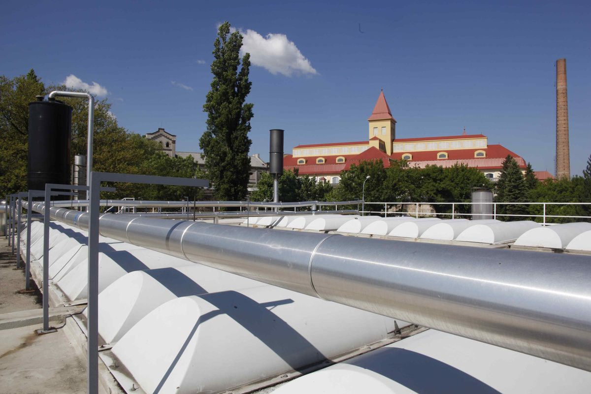 Covered METHANATOR UASB reactor with the Dreher brewery buildings behind, Budapest, Hungary