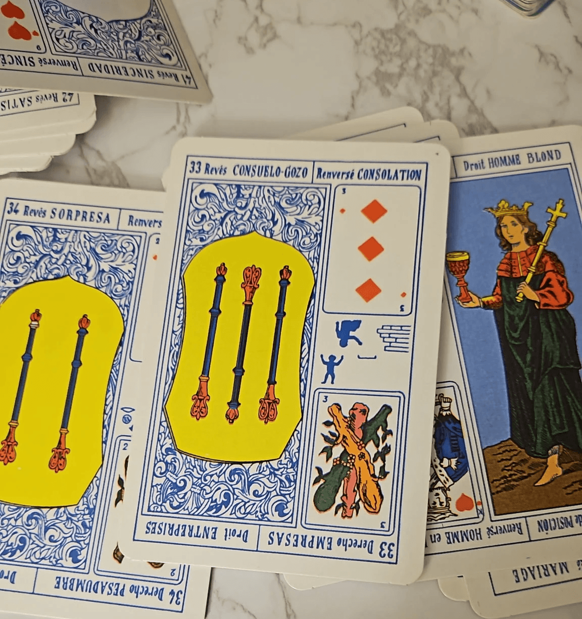 A person with curly hair sits at a desk, working on a laptop in a cozy, well-lit environment.