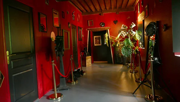 Couloir du gîte avec portes inspirées des loges de cinéma à La Tuilerie du Cinéaste