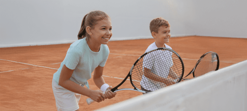 Students participating in an outdoor tennis activity led by a HOKALI educator