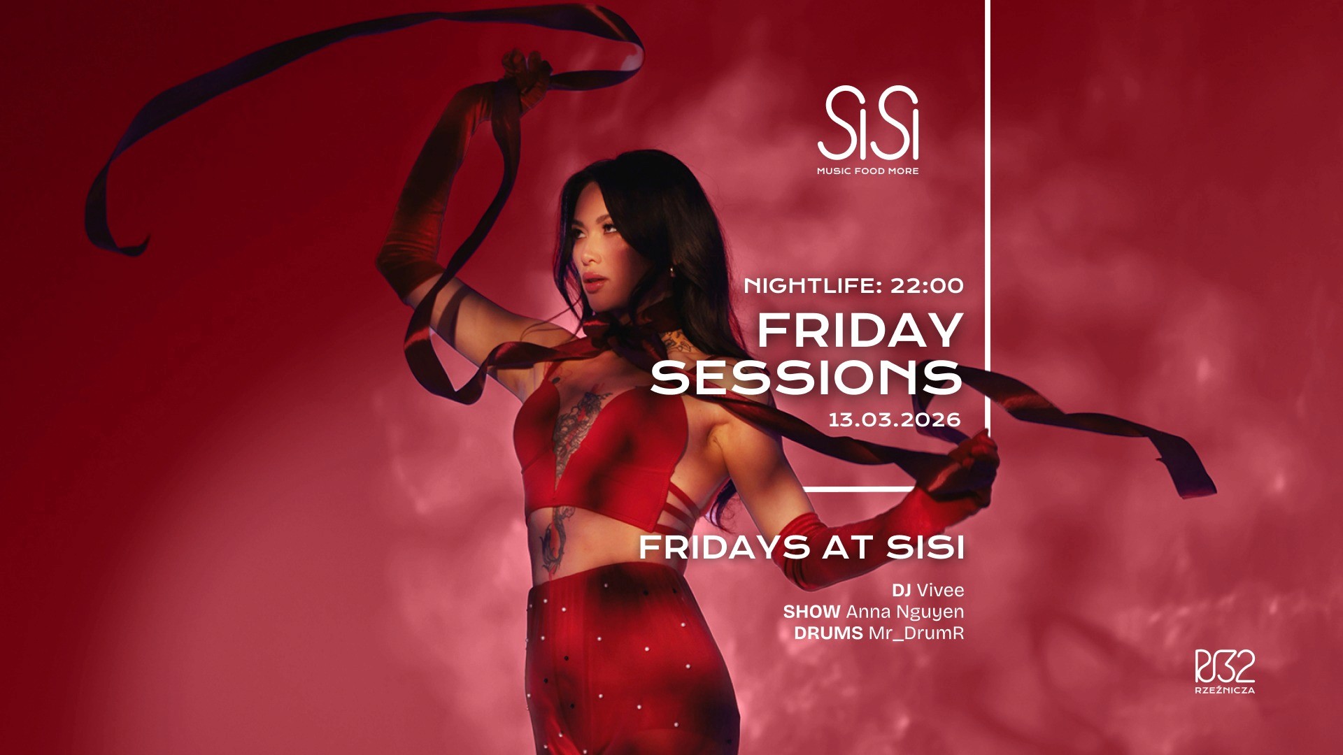 A winding road cuts through rocky terrain, surrounded by patches of green grass and illuminated by sunlight.