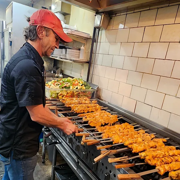     Cafe Izmir chicken kabobs being grilled for catering
