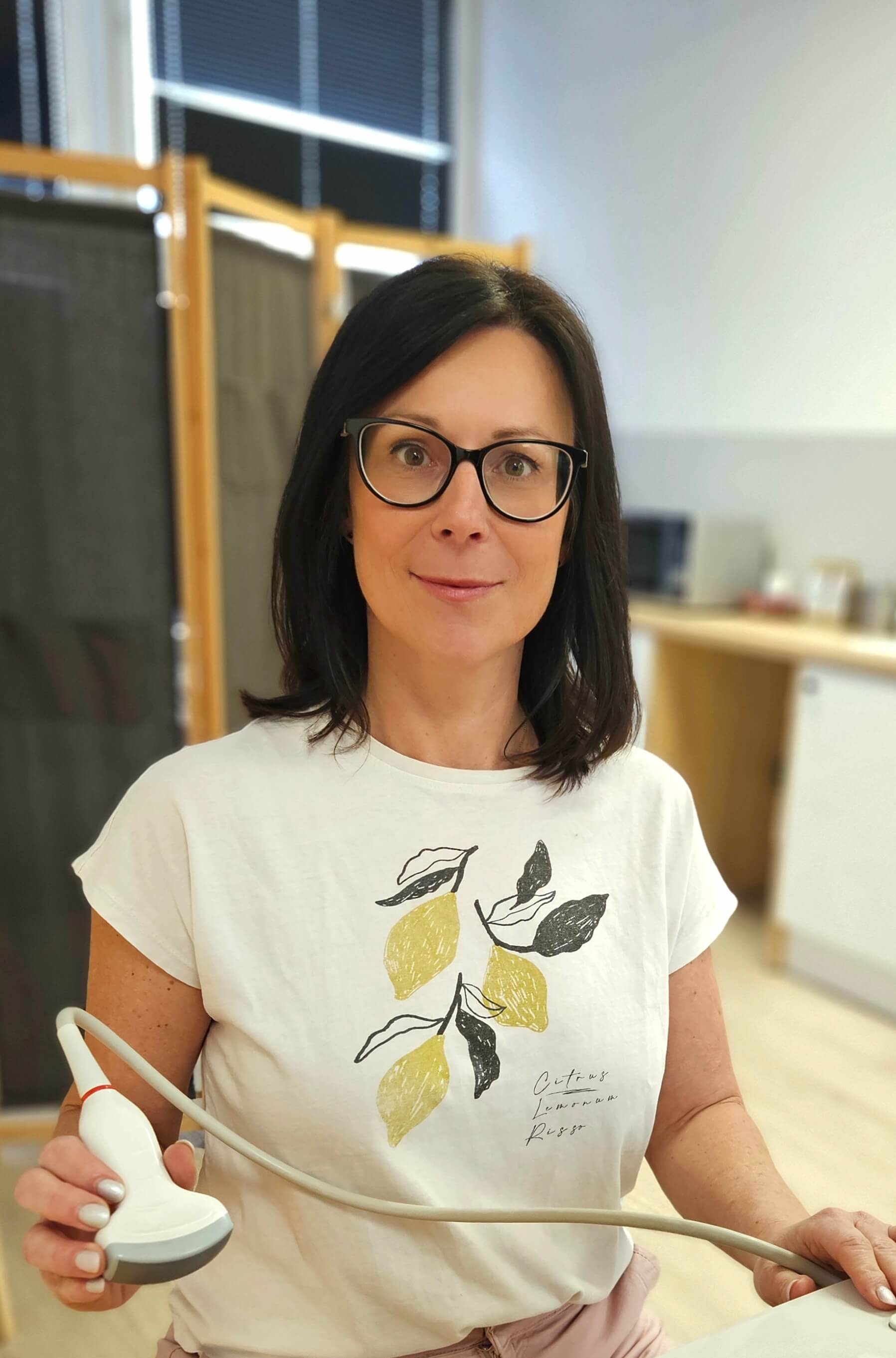 a woman in a white lab coat pointing at something