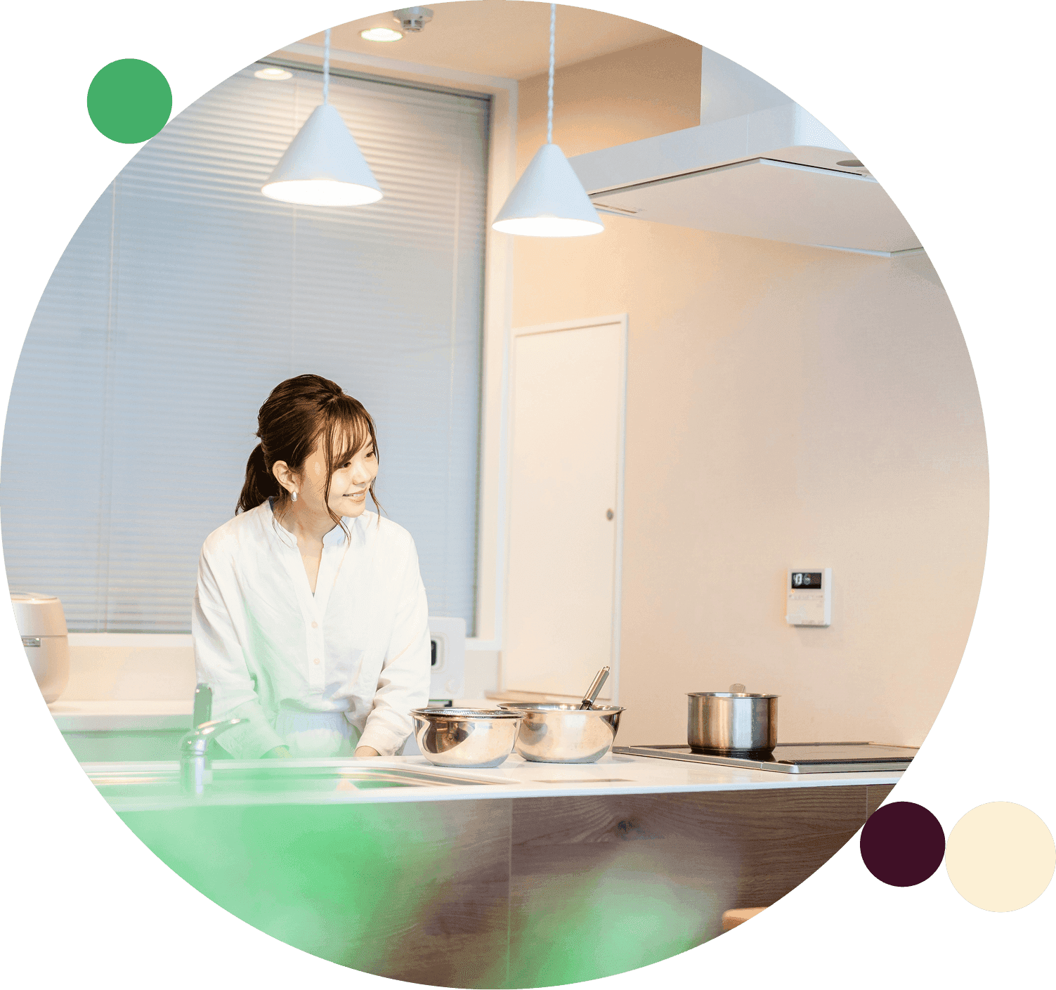 Woman stands in a modern kitchen looking toward the counter with pots on the stove