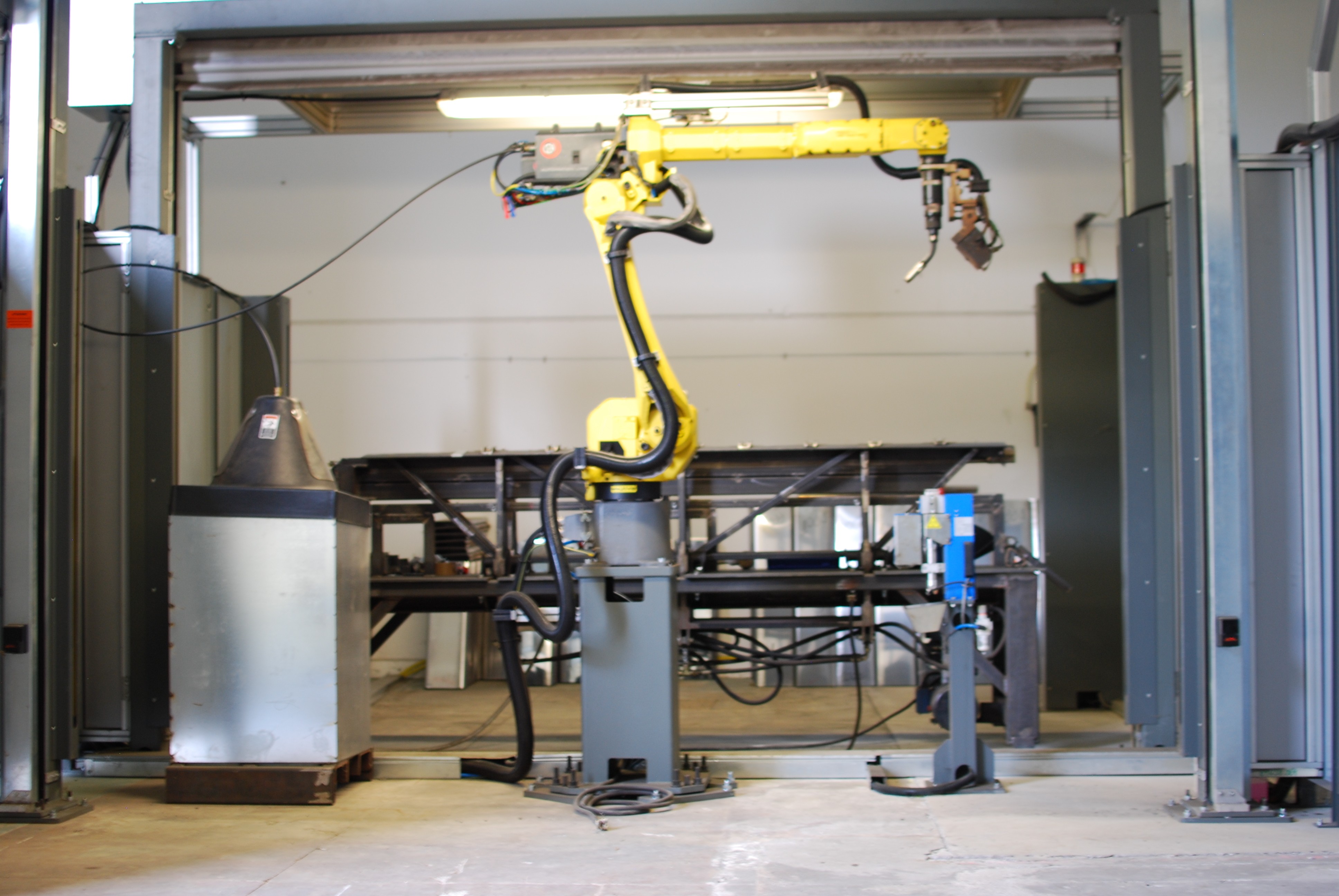 a man welding a piece of metal in the dark