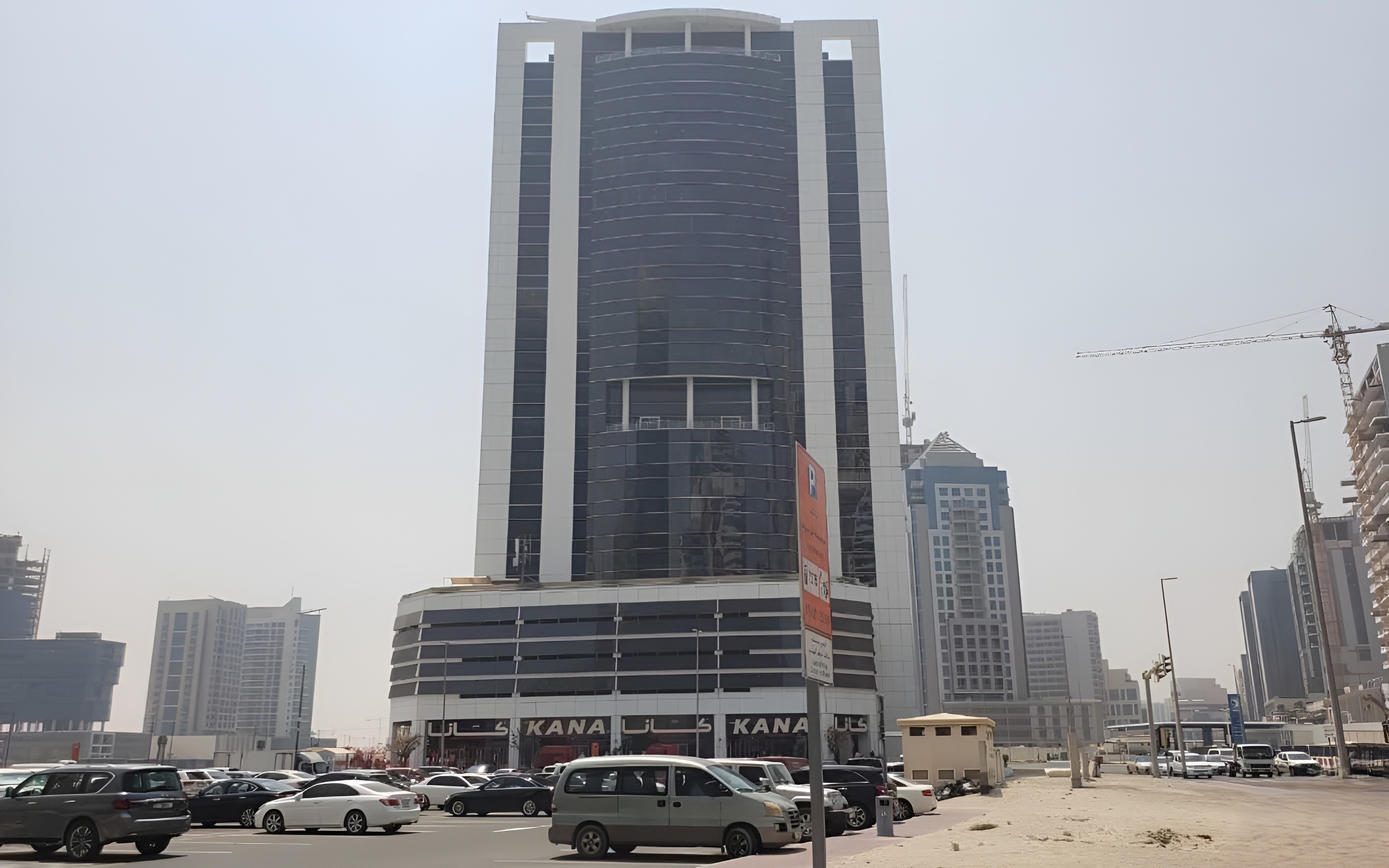 Low angle view of glass Fifty One Tower facade in Business Bay, Dubai. Prime commercial real estate for lease.