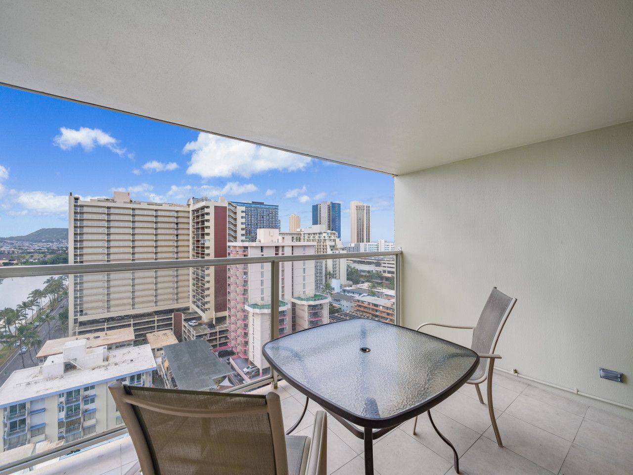 Private lanai with table and chairs overlooking Waikiki high-rises