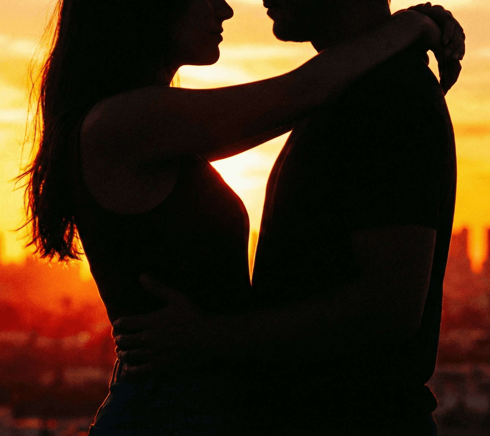 smiling woman sitting on grass during daytime