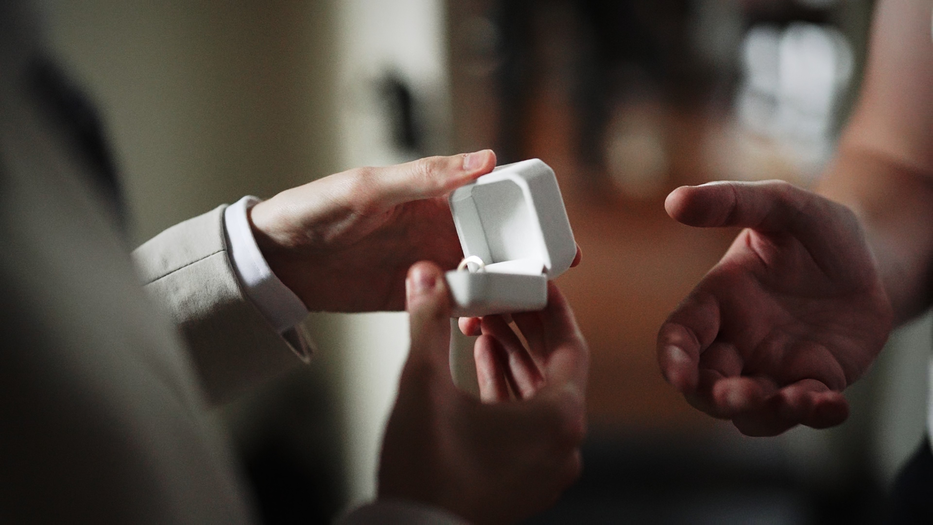 A man hugs a woman from behind