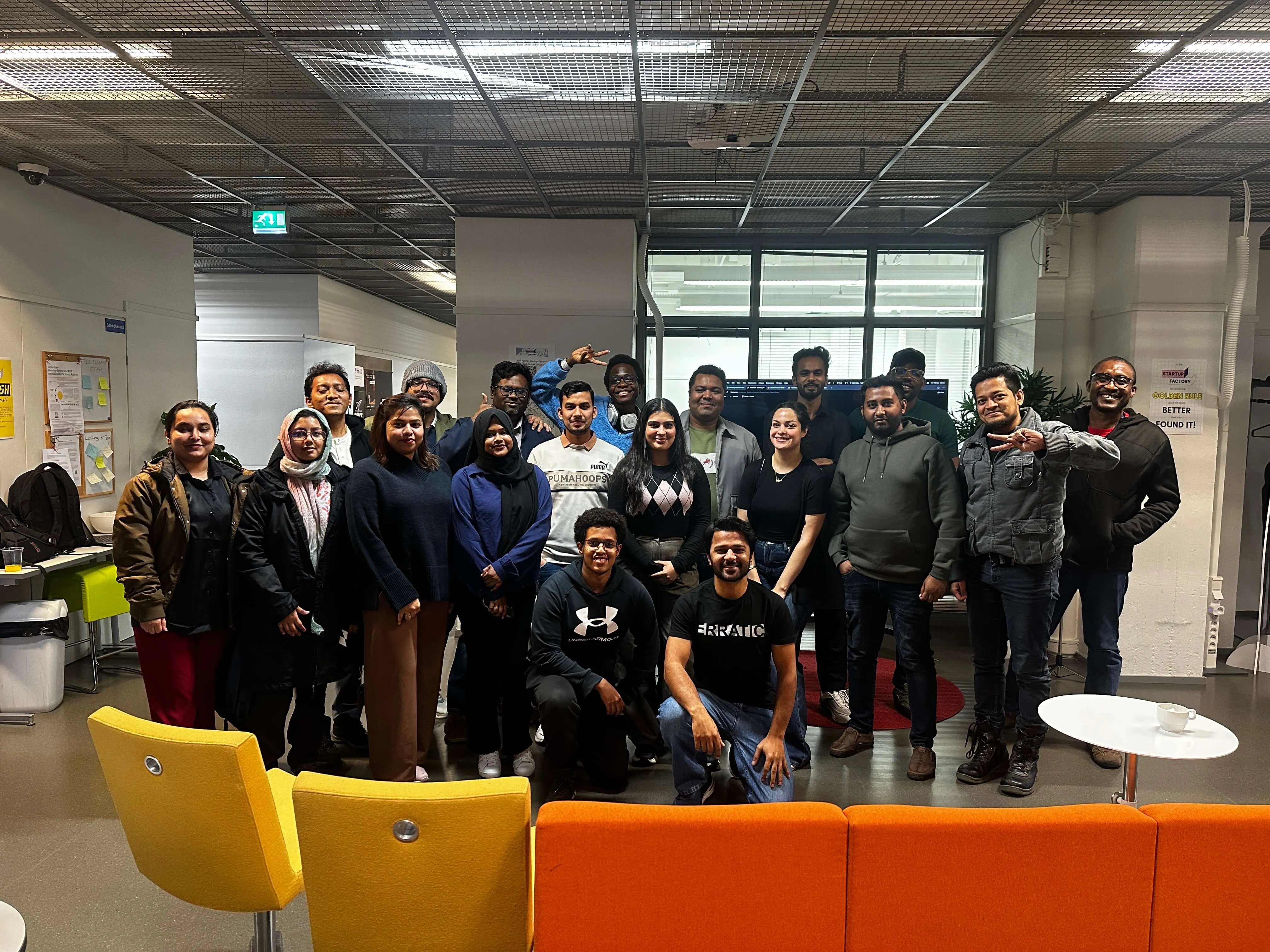 a diverse group of colleagues poses for a photo together in a modern office space, smiling