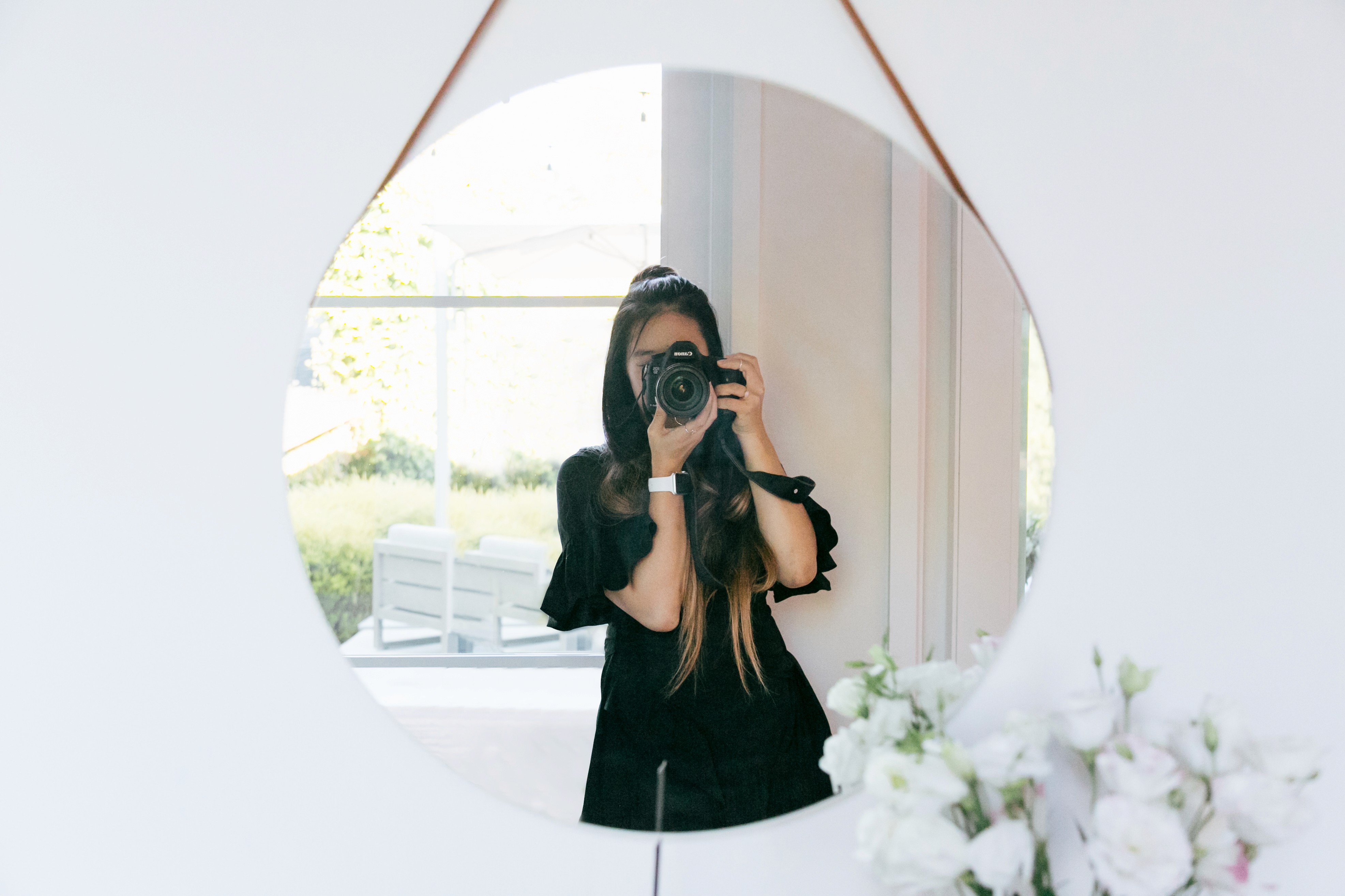 Woman with camera in a mirror