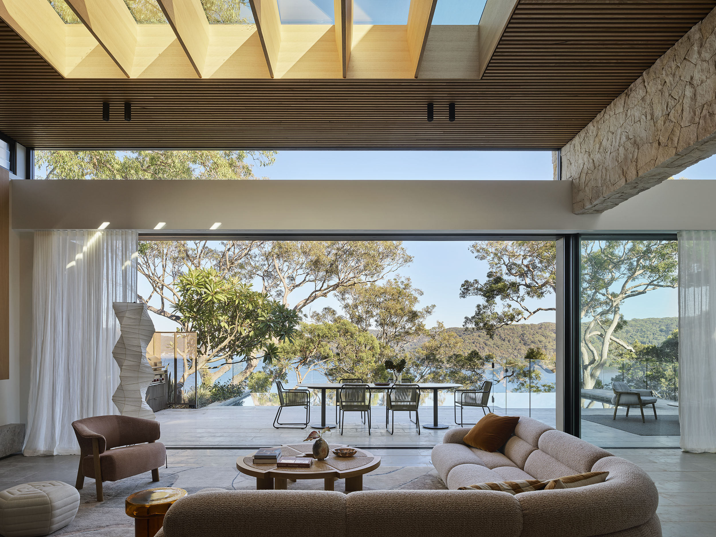 Futuristic glass skyscraper with a bold angular design, reflecting the surrounding city skyline at dusk.