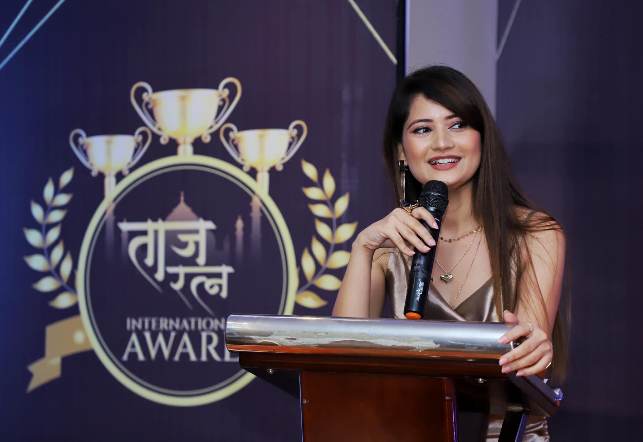 Almas Khan anchoring a corporate conference on stage