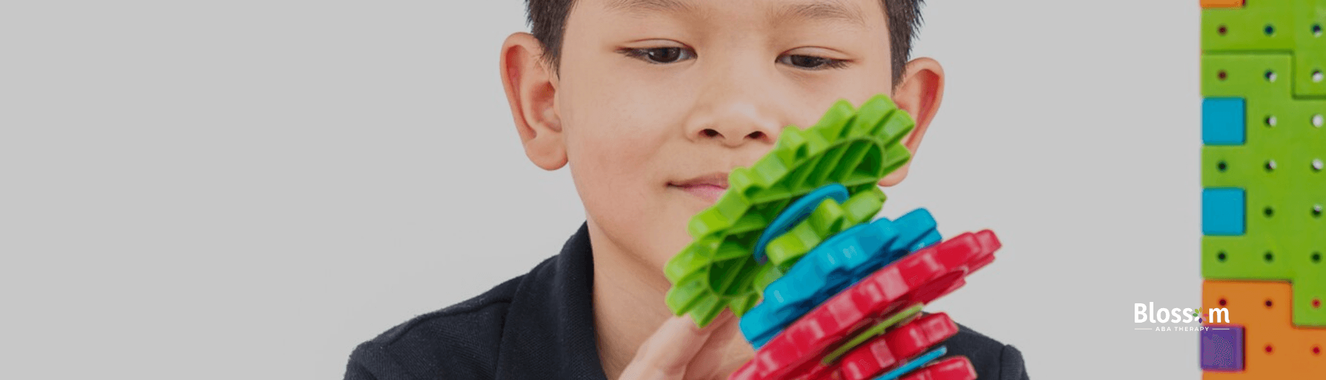 An autistic hcild playing with colorful fidget toys