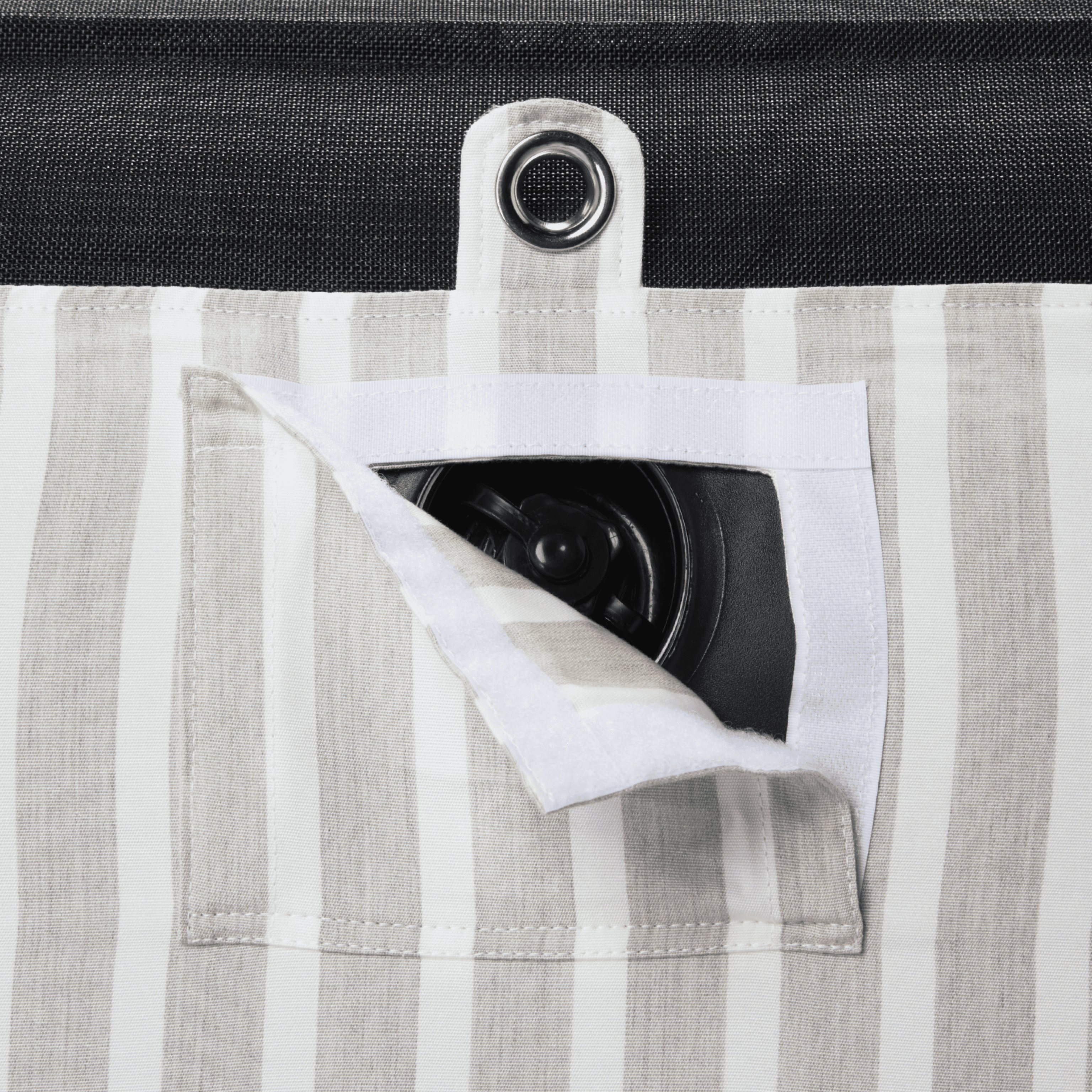 Close-up of pool float showing beige-and-white canvas, inflation valve, and silver stainless eyelet