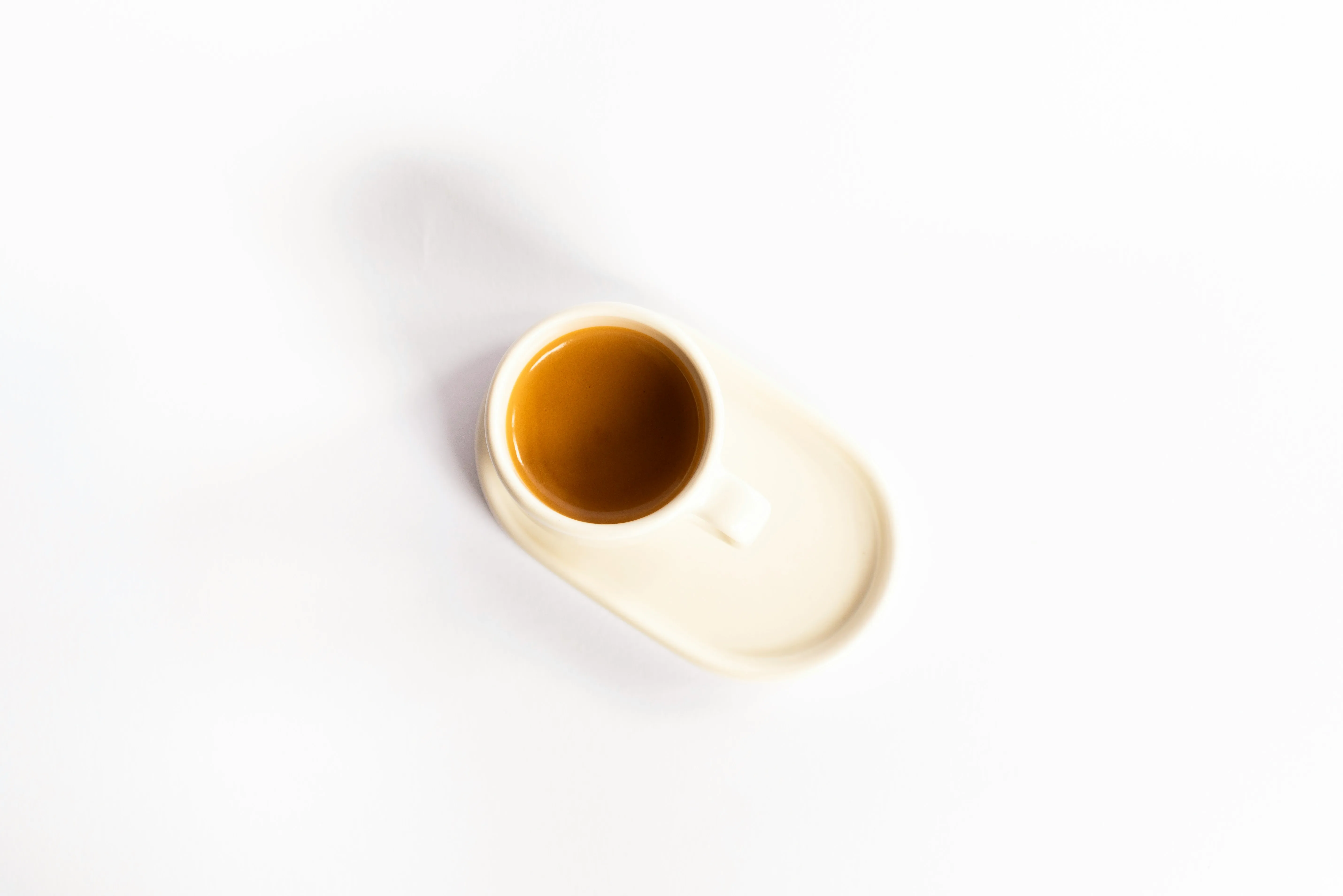 A cup of coffee on a white saucer