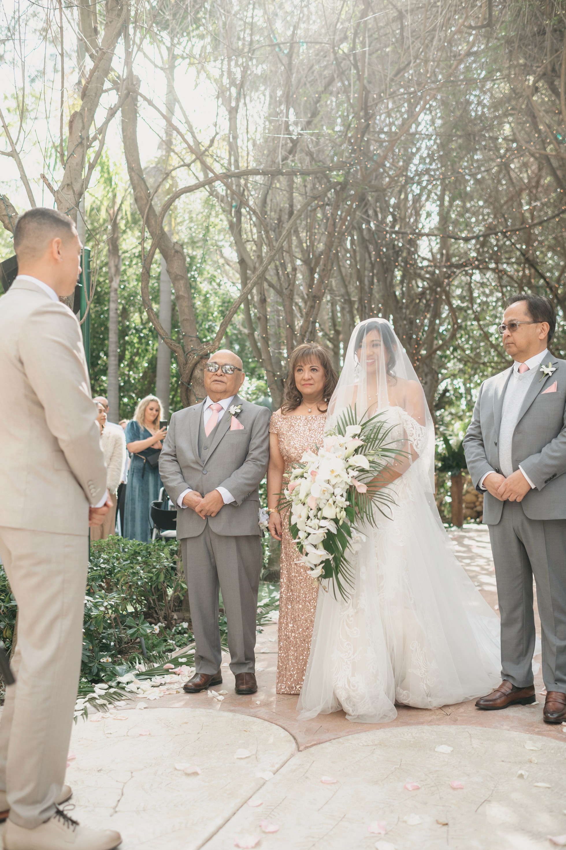 Bride walking down the aisle at outdoor garden ceremony