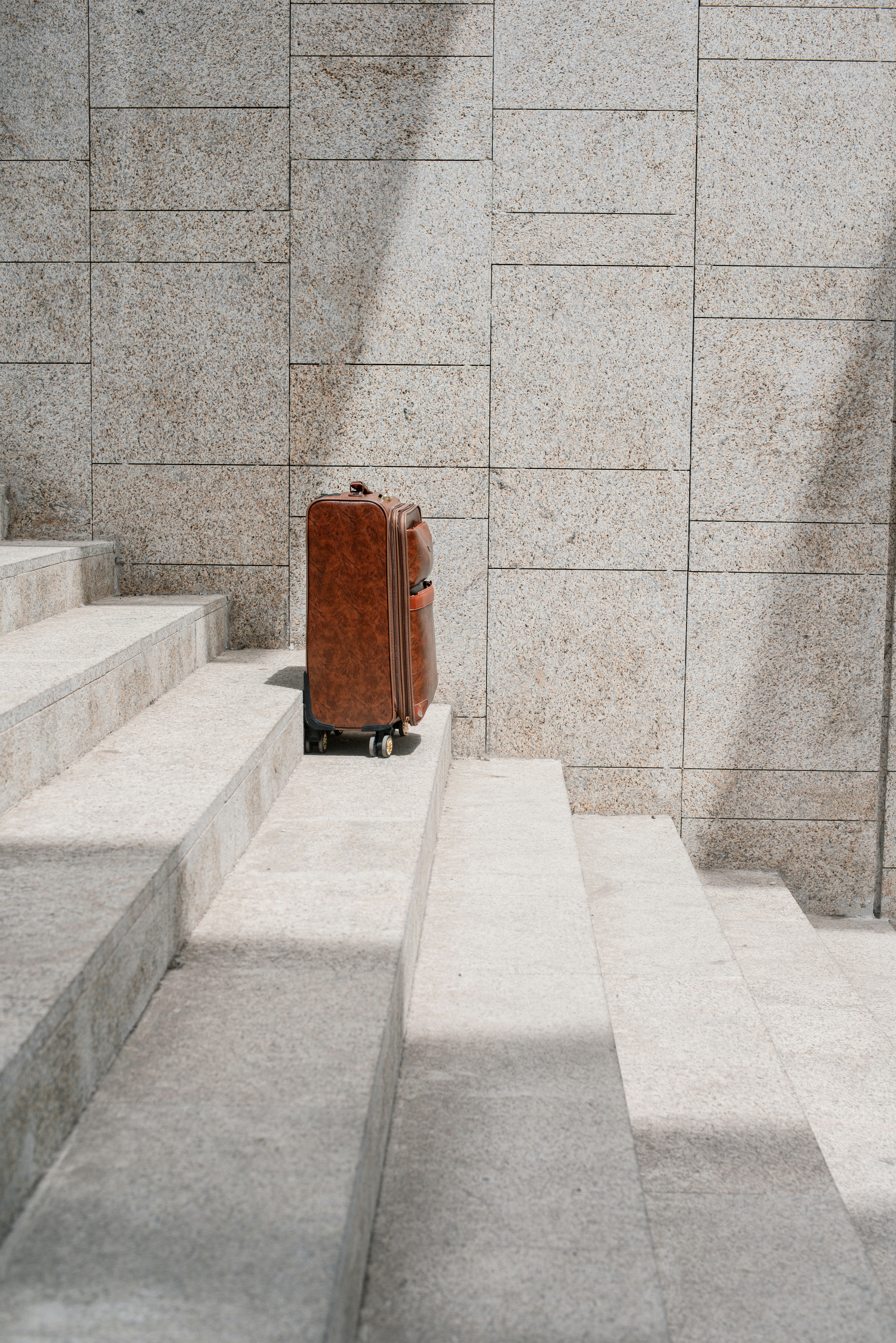 A photo of brown travel bag on stairs
