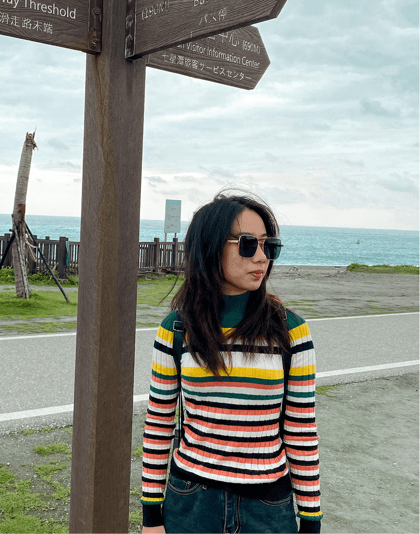 Jodith Valerie standing in front of the beach, travel moment from product designer portfolio