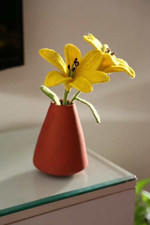 Handmade crochet lily flowers in decorative vase for home decor