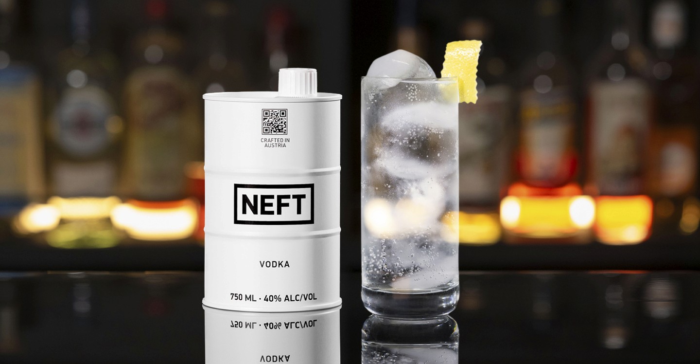 A NEFT Barrel and a glass of Vodka Tonic on a bar counter.