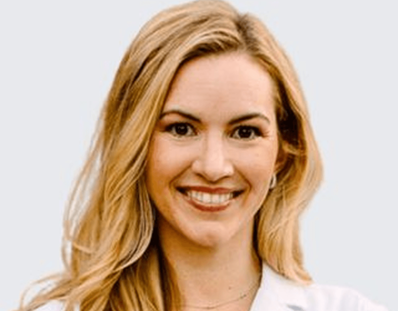 a man in a white shirt and tie posing for a picture