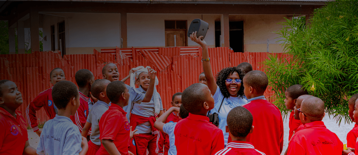 Kids playing with Ardent Hope Leader during outreach