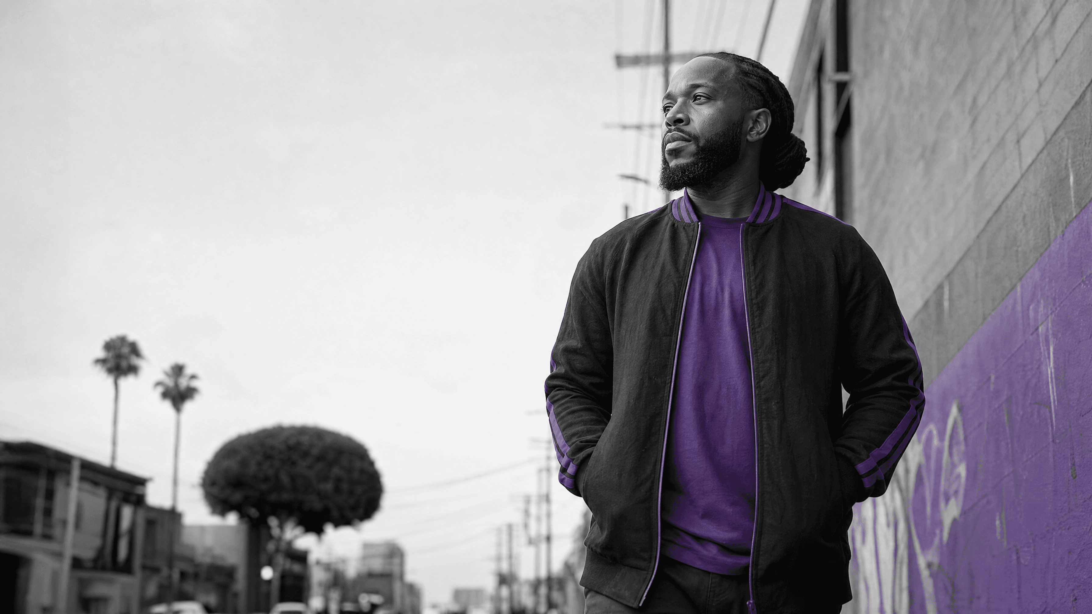 Justice-impacted adult moving forward through a South Los Angeles community.